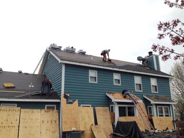 roofers installing a new roof on house